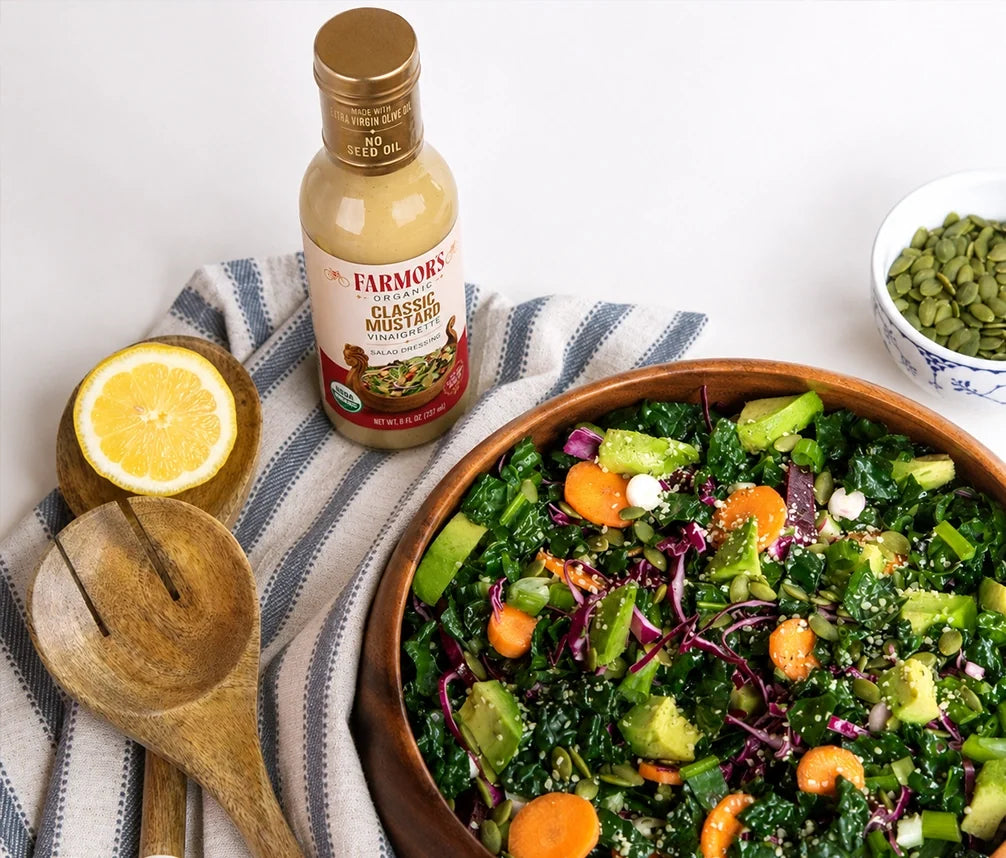 Overhead kale salad with a bottle of Farmor’s Classic Mustard vinaigrette
